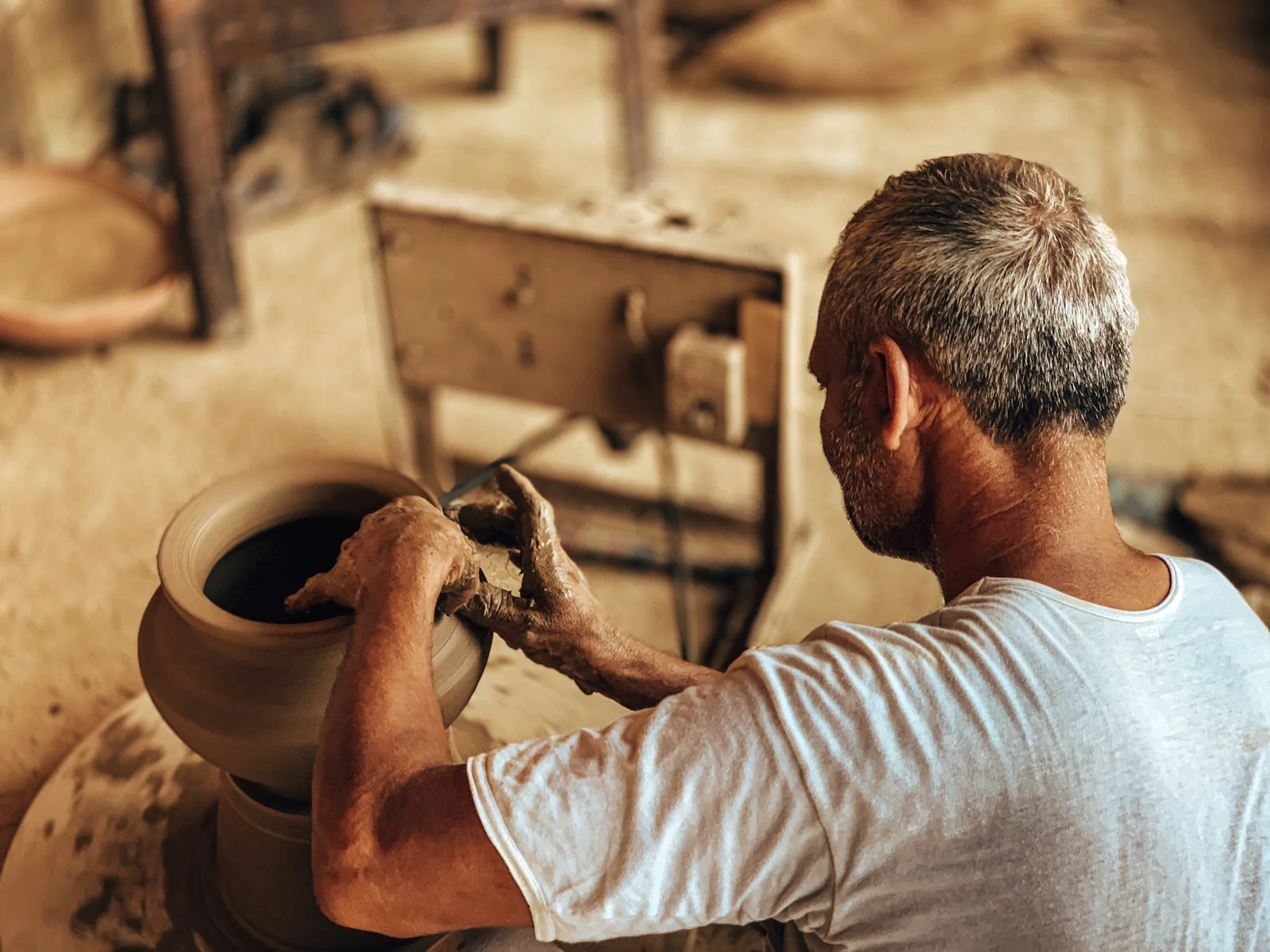 Arjan Singh shaping a clay pot
