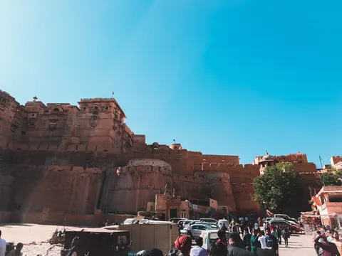 Fort walls tower above the movement of the street.