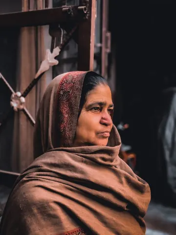 A thoughtful gaze from a shaded doorway.