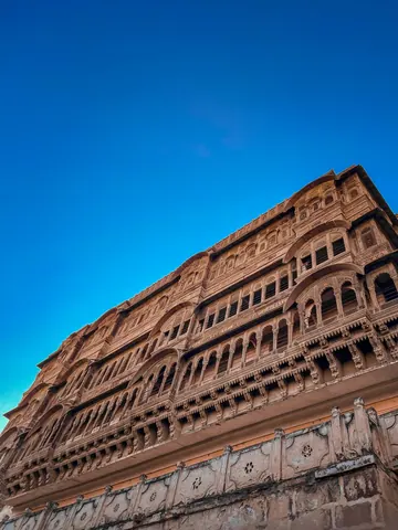 Rows of carved windows rise above the street.