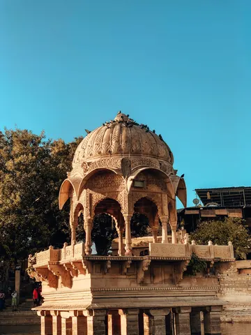 Carved pillars support a small domed pavilion.