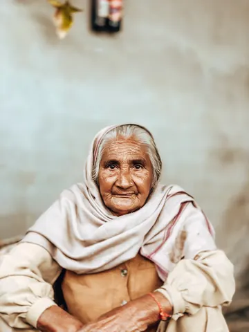 An elder's gentle smile in the doorway.