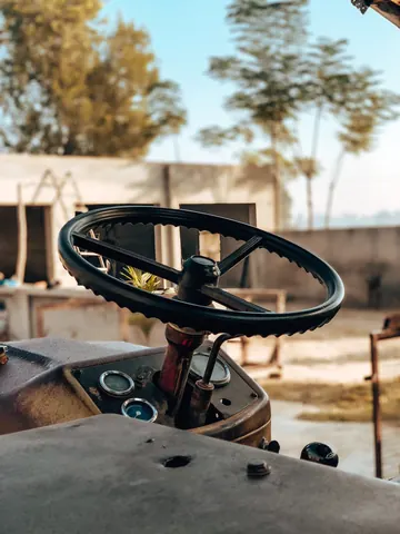 A tractor's steering wheel waits for the next journey.