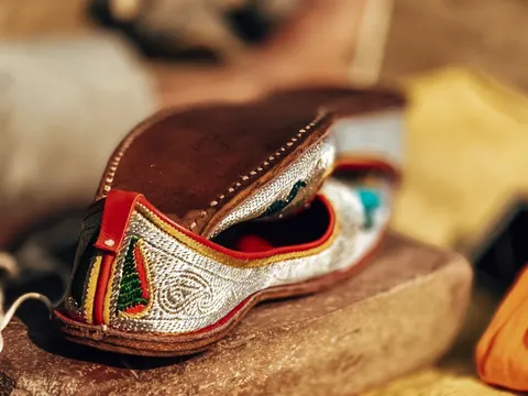 Colour and texture in the curve of a handmade shoe.