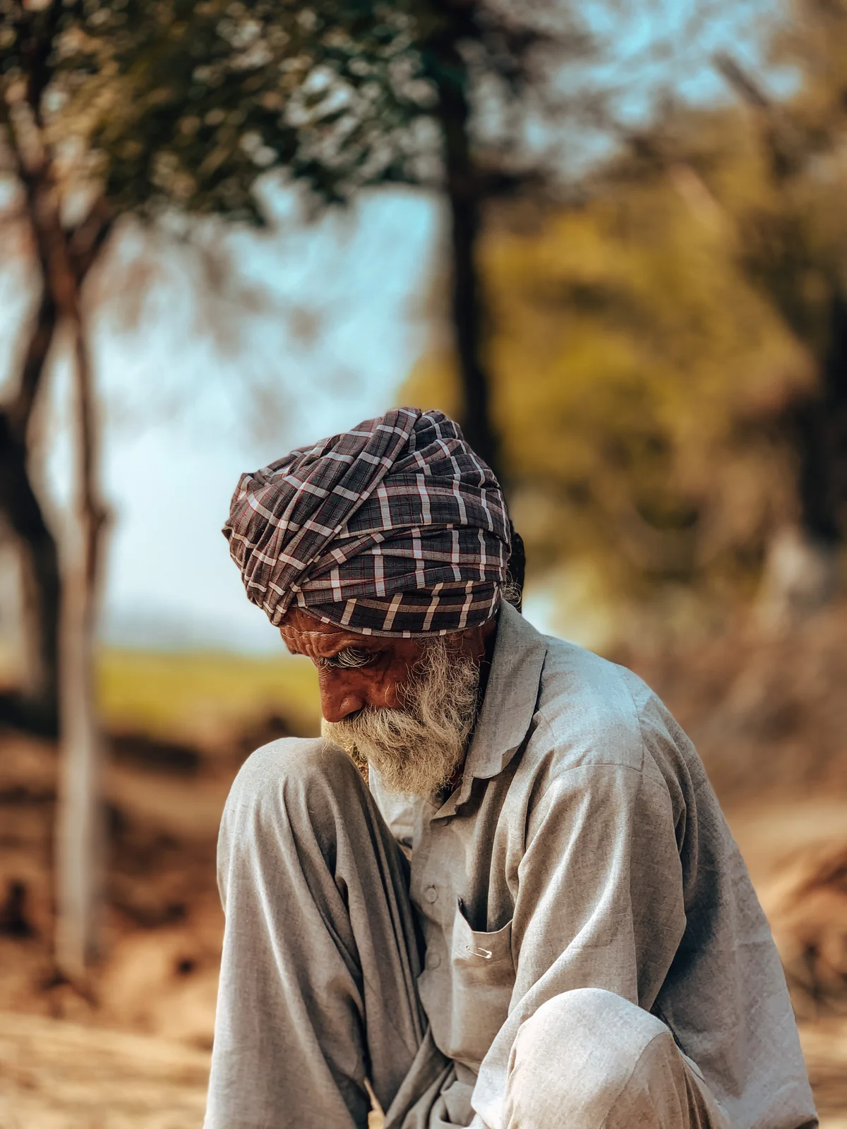 Portrait of Tela Singh seated outdoors
